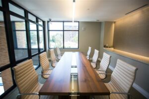 bright conference room with long table and office chairs